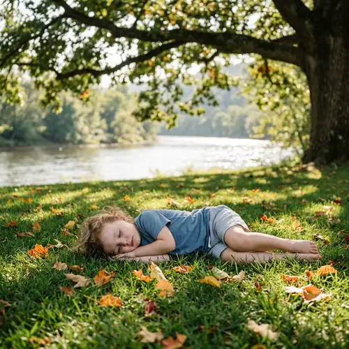 Tranquil Image of Unconscious Child on Grass Near River