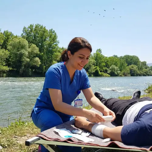 Turkish Descent Nurse Treating Patient by River