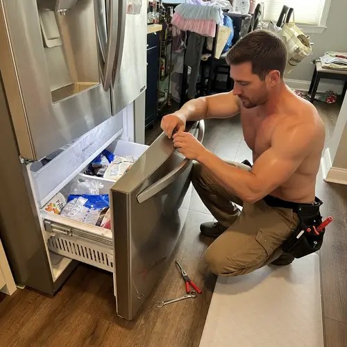 Handsome Handyman Fixing Freezer Drawer
