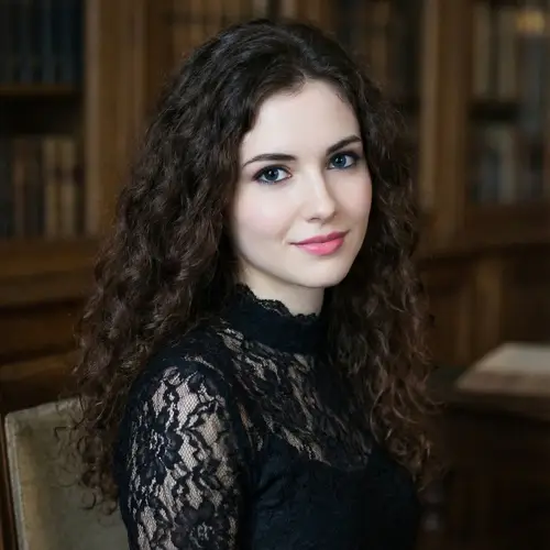 Brunette with Long Curls and Dark Blue Eyes in Black Lace Dress
