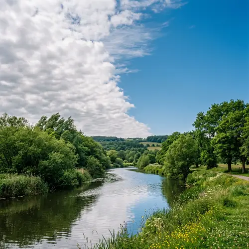 Tranquil River Scene with Blue Sky and Fluffy Clouds