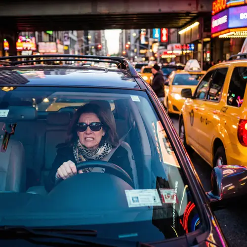 Frustrated Mother in SUV Amidst Chaotic Traffic
