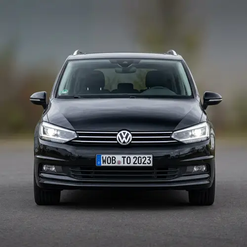 Front View of Volkswagen Touran in Deep Black | VW Emblem & Headlights