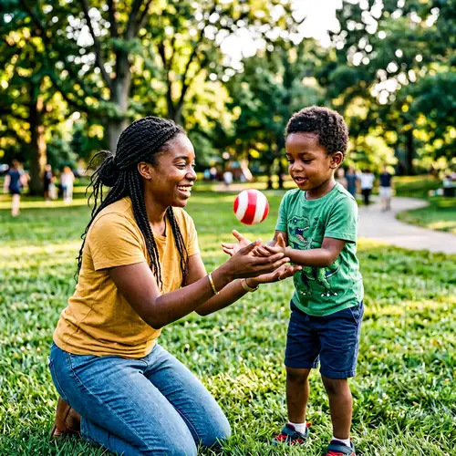 Young Black Mother Teaches Son to Catch a Ball