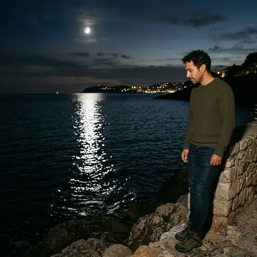 Hispanic Man Observing Moon Reflection in Sea