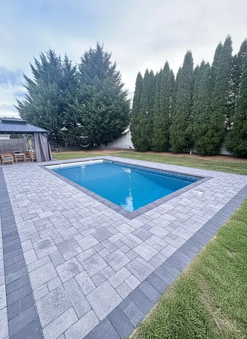 Stunning New Pool with Gray Pavers & Privacy Trees