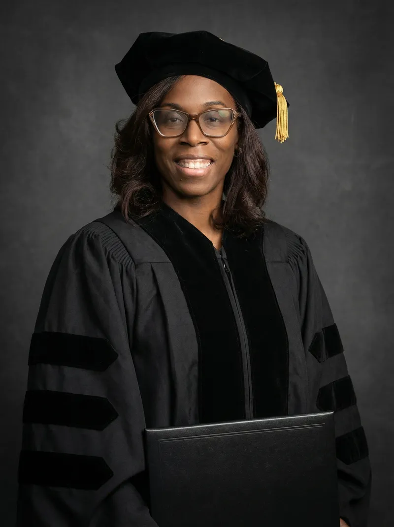 Official Portrait of Doctoral Graduate in Cap and Gown