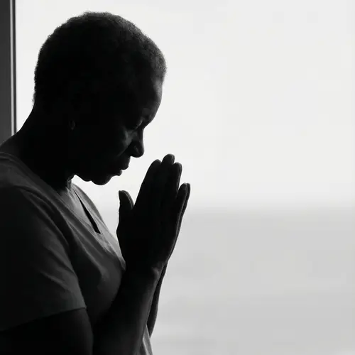 Silhouette of an African-American Woman Praying