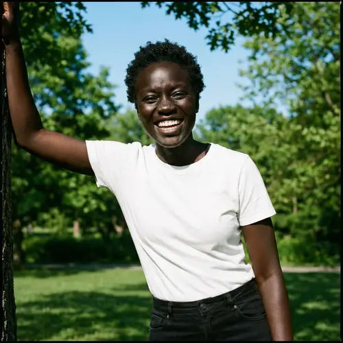 Energetic Black Person Smiling in Urban Park | Website Name