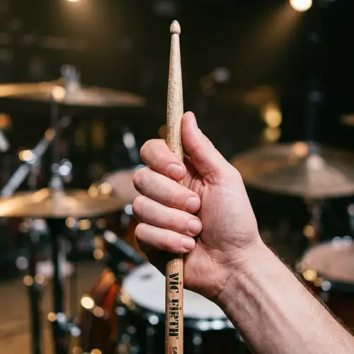 Close-Up Image of Caucasian Hand Gripping Wooden Drumstick
