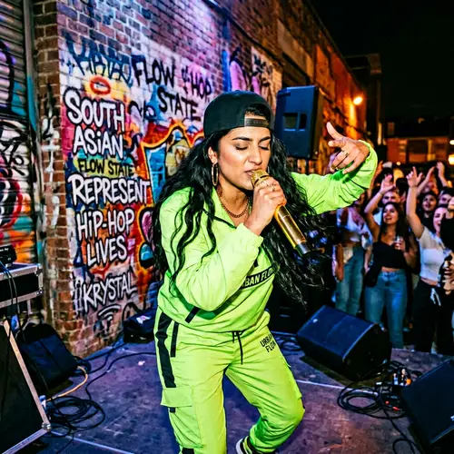 South Asian Female Rapper Artist in Neon Green Tracksuit