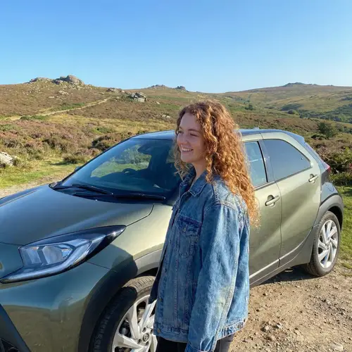 Young Woman with Red Hair in Dartmoor with Toyota Aygo X
