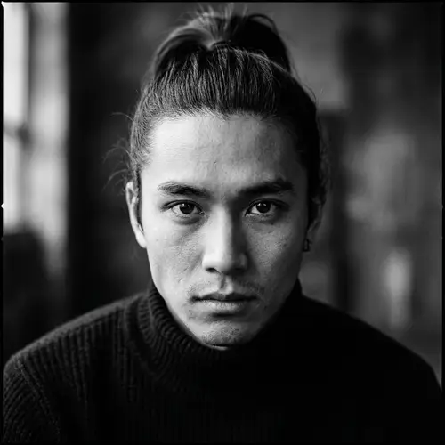 Expressive Young Asian Man with High Ponytail | Black and White Portrait