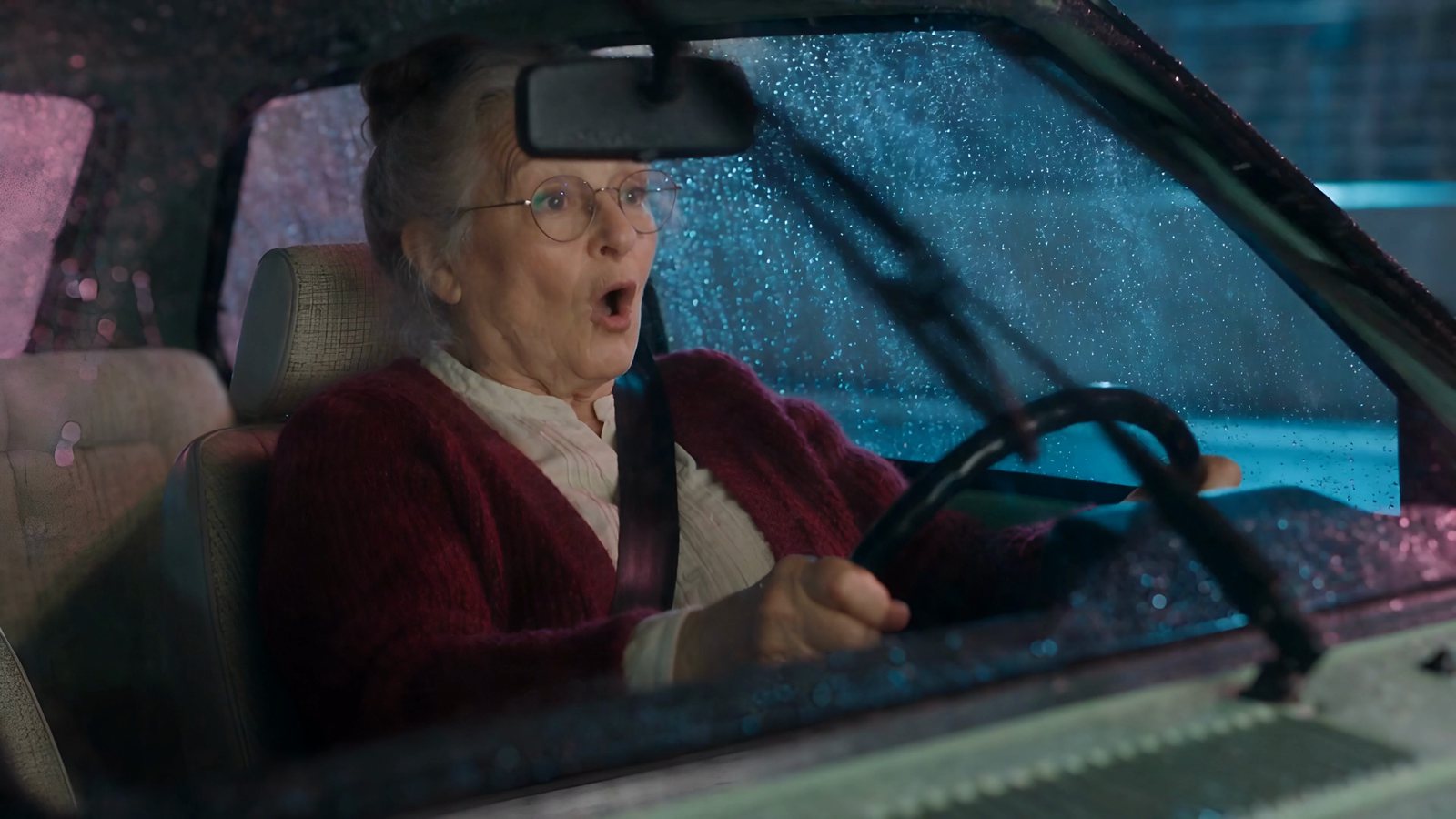 Grandma Rose at the wheel of her hatchback in the rain, in a Seedance 2.5 AI short film
