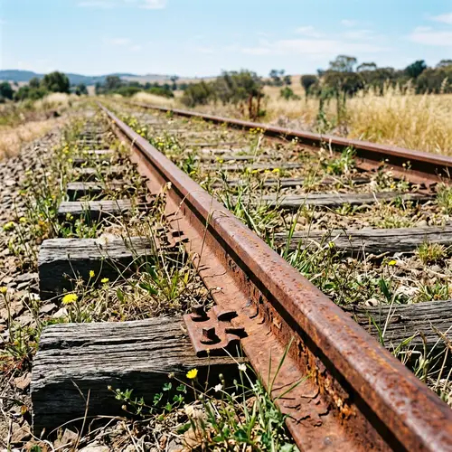 Rusty Train Rails - Oxidized Metal Tracks in Sunny Environment