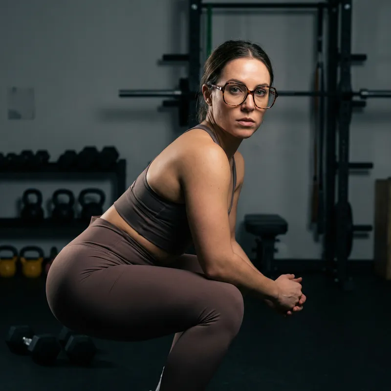 Stylish Gym Fashion: Female Squatting Pose