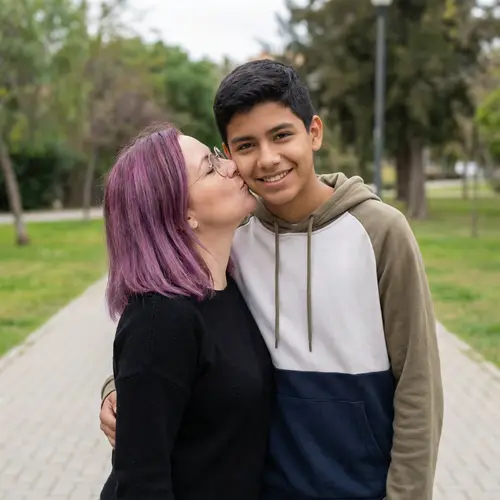 Caucasian Woman with Glasses Kissing Hispanic Teenage Boy