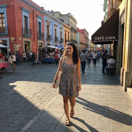 Young Hispanic Woman Walking in Urban Setting | Trendy Summer Outfit