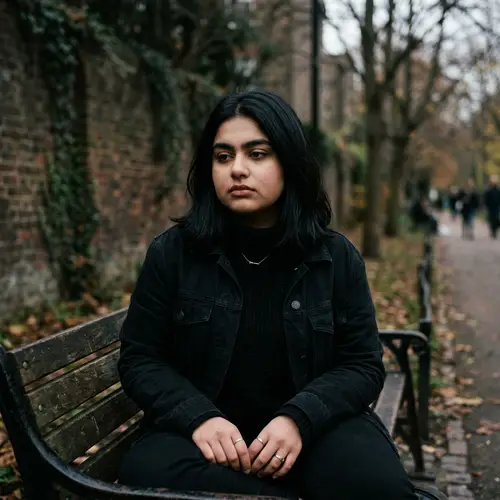 Brooding South Asian Girl in Black Ensemble with Short Hair