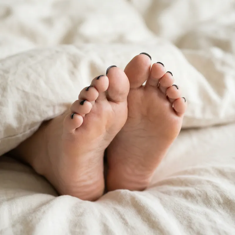 Beautiful Female Feet with Black Nail Polish