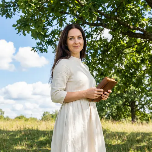 Beautiful Woman with Dark Hair and Blue Eyes in White Dress