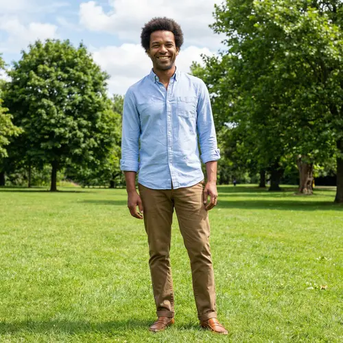 Friendly Smiling Man Outdoors | Casual Style with Afro Hair