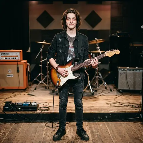 Caucasian Male Teenager Guitarist with Striking Blue Eyes