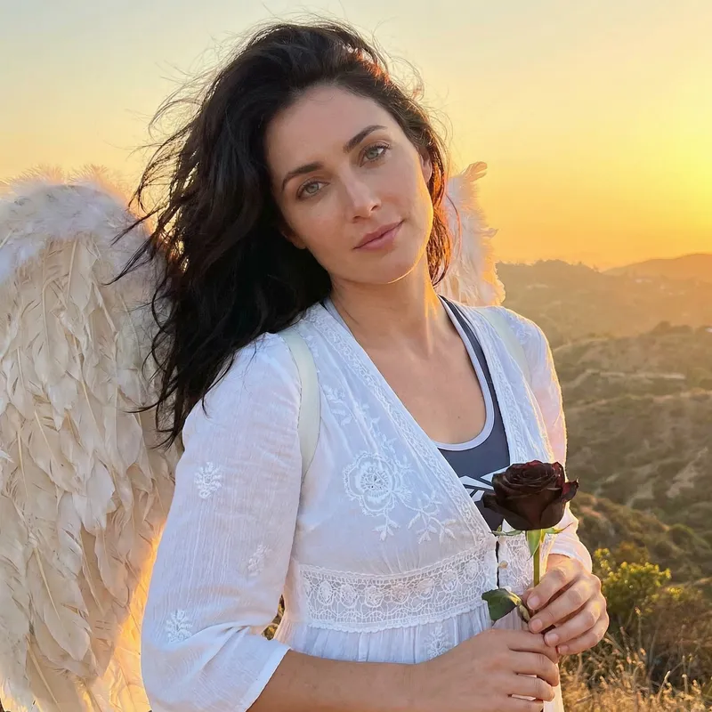Beautiful Angel at Sunset with Black Rose