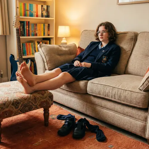 Cozy Living Room with Teenage Model in School Uniform
