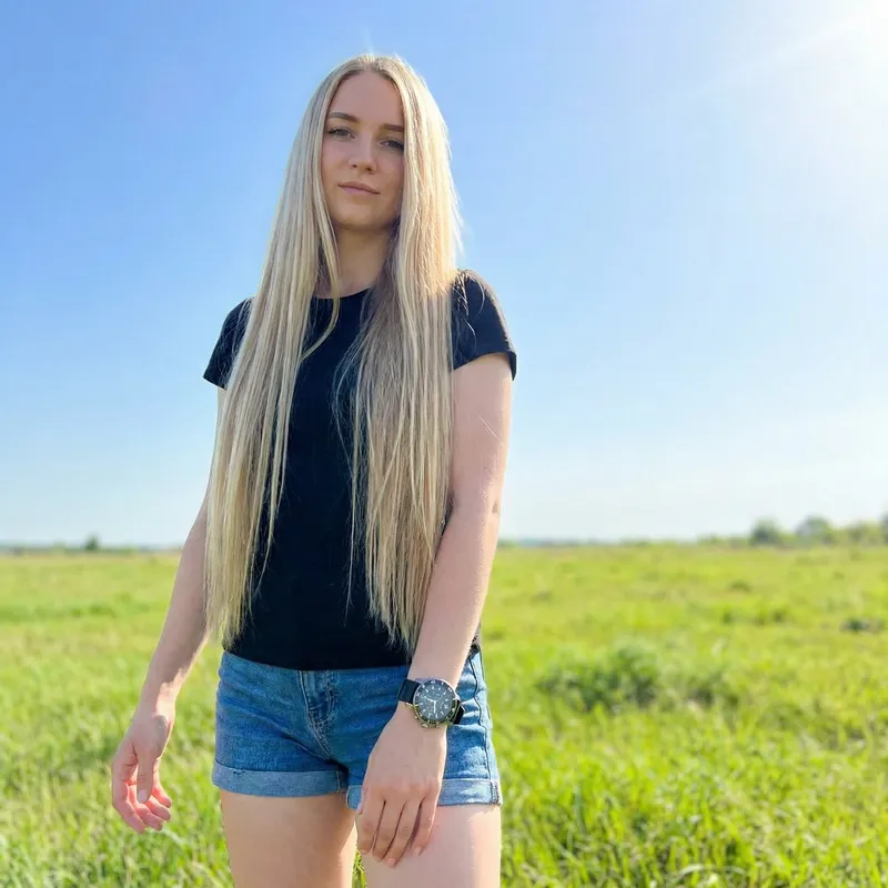 18-Year-Old Slim Caucasian Girl with Knee-Length Blonde Hair Outdoors