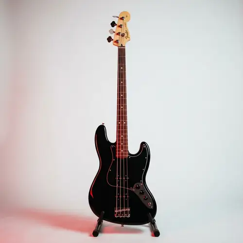 Sleek Black Bass Guitar with Bold Red Light | Dramatic Musical Scene