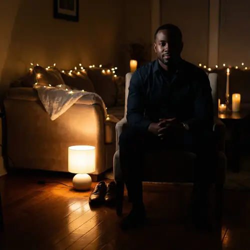 Mysterious Black Man in Chair - Atmospheric Portrait