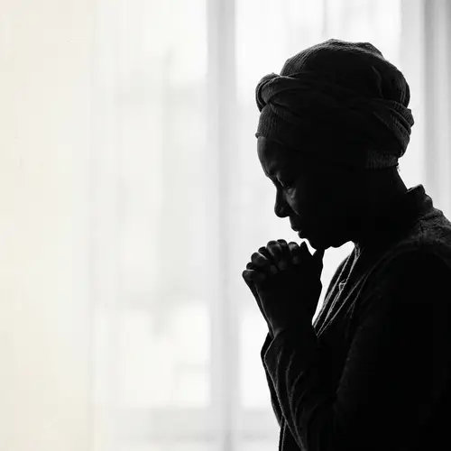 Silhouette of Praying African-American Woman