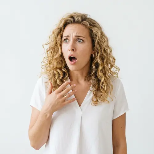 Surprised Blonde Woman in White Blouse - Stunning Shot