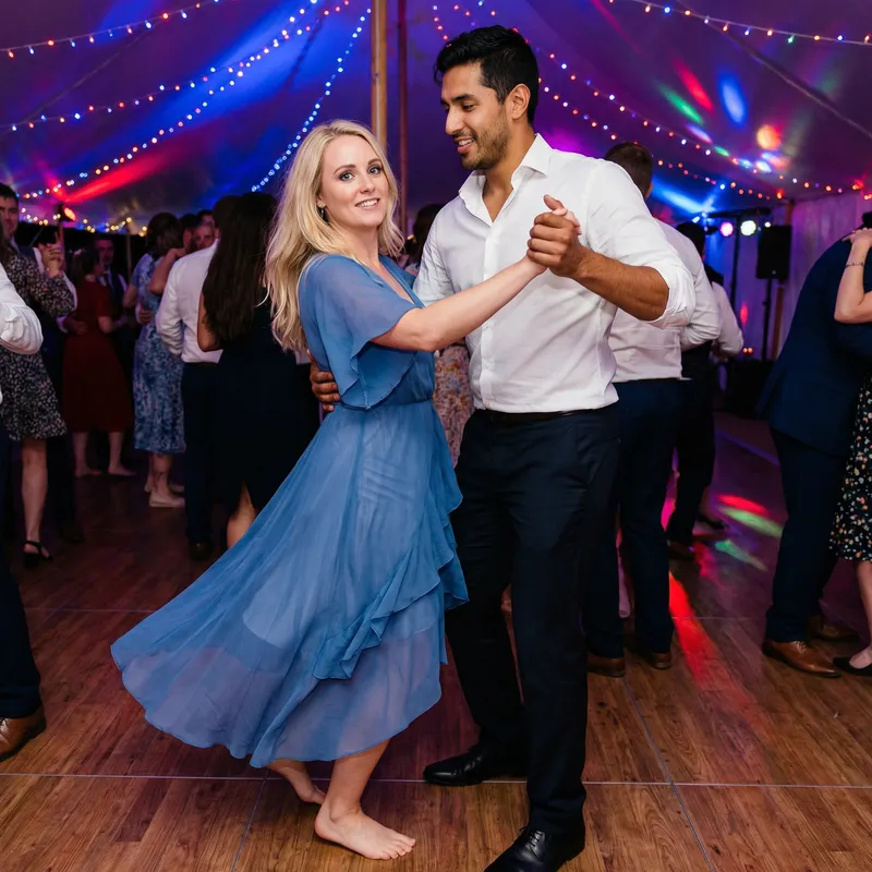 Elegant Dance: Blonde Girl & Brunette Man in Blue Chiffon Dress