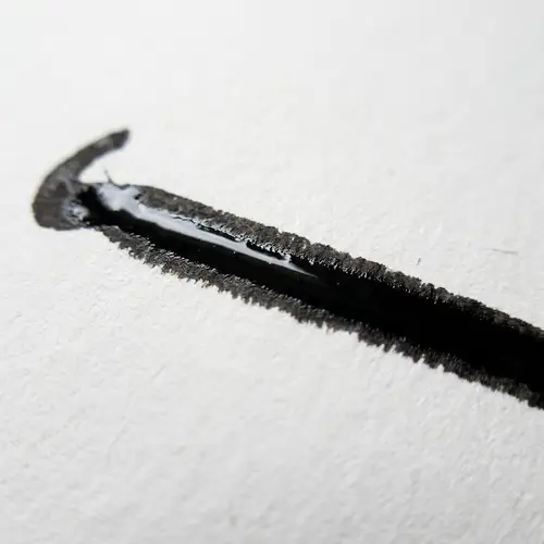 Rich Black Pen Stroke on White Paper | Artistic Expression