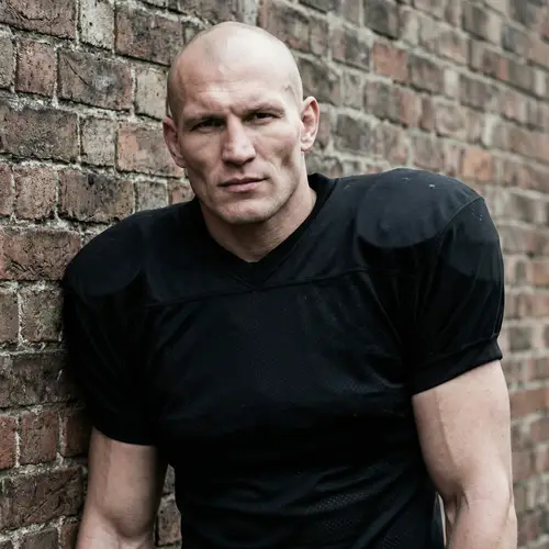 Bald Guy in Black Football Shirt - Strong Physique