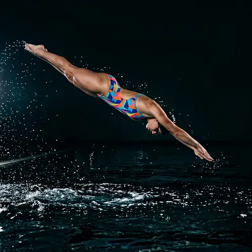 Professional Swimmer Diving into Endless Pool
