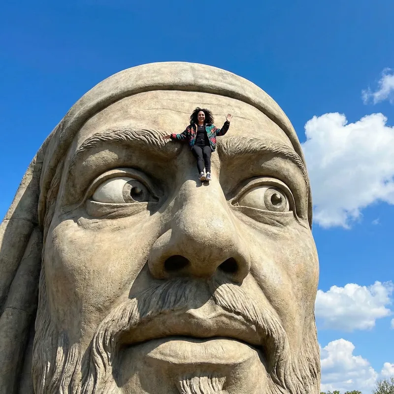 Giant Man with Tiny Woman on His Nose: A Playful Scene Captured