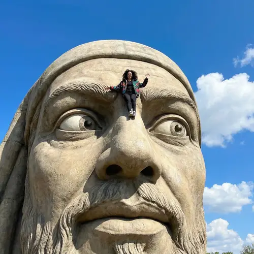 Colossal Middle-Eastern Man with a Tiny Hispanic Woman Balancing on His Nose