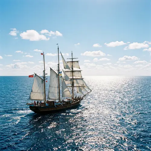 Sailboat Gliding in Expansive Ocean with Glistening Sunlight