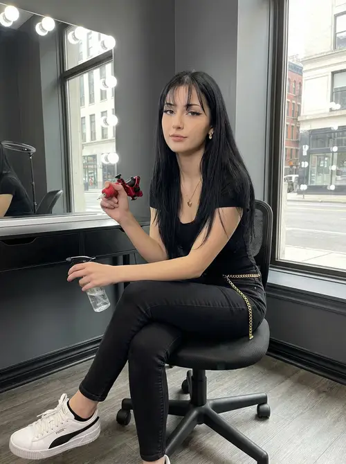 Stylish Tattoo Artist with Long Black Hair