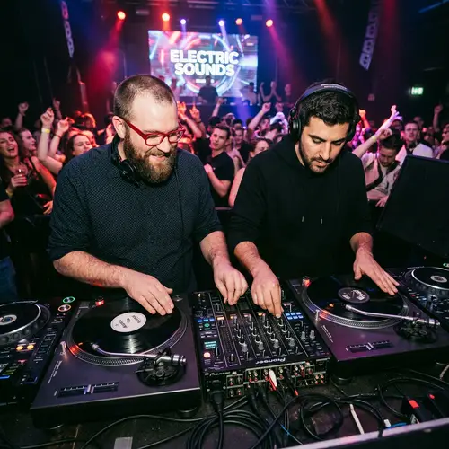 Expert DJs at Turntables: Red Glasses Bearded DJ & Partner