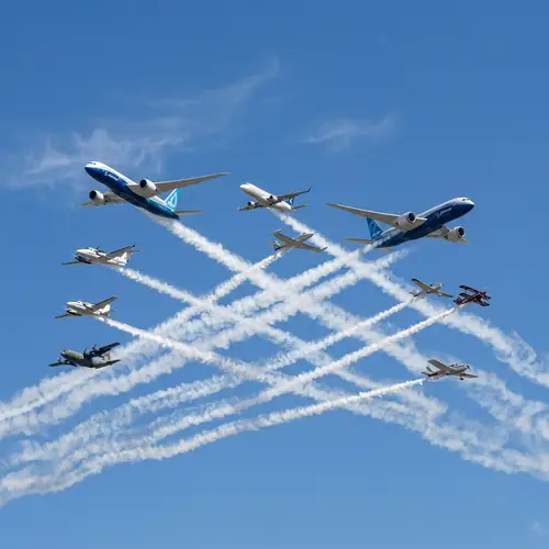 Intricate Patterns in the Sky: 8 Airplanes Creating Smoke Trails