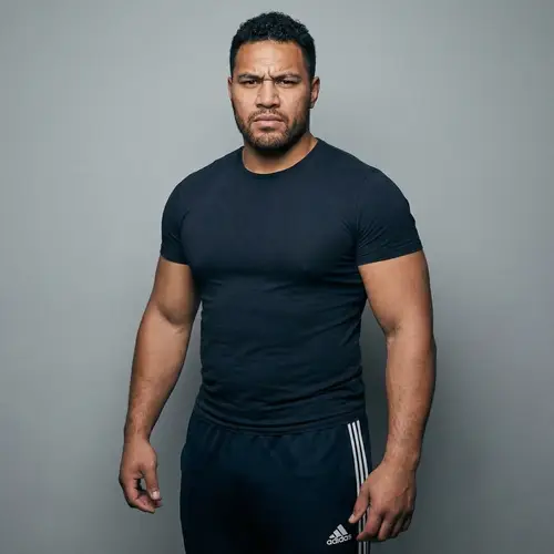 Determined Muscular Man in Fitted Shirt & Trackpants