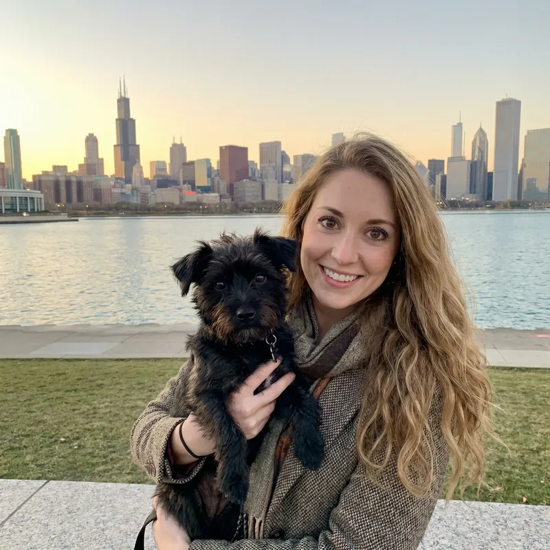 Stylish Woman with Long Hair and Brown Eyes in Chicago City with her Dog