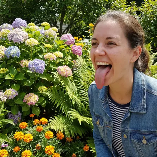 Woman with Huge Tongue in Colorful Garden