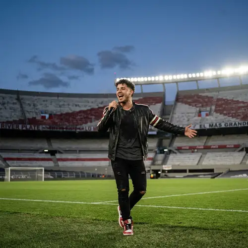 Energetic Hispanic Male Singer Performance at Argentinian Club Stadium