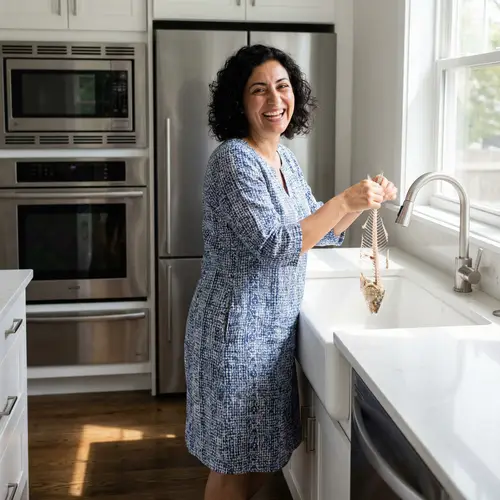 Graceful Middle-Eastern Woman Holding Fish Skeleton in Modern Kitchen
