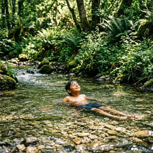 Tranquil Scene of South Asian Boy Swimming in Brook